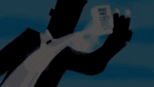 a man in a suit and tie is holding a piece of sugar in his hand .