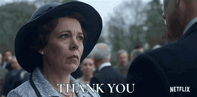 a woman in a hat is standing next to a man and says thank you
