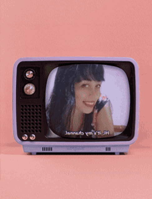 a purple tv with a picture of a woman on it