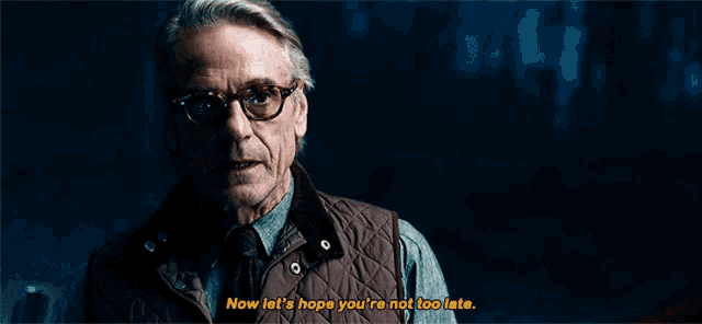 a man wearing glasses and a vest says " now let 's hope you 're not too late "