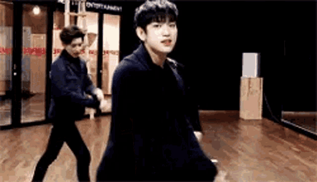 two men are dancing in a dance studio .