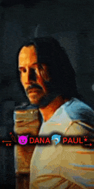 a man with long hair and a beard is next to a dana paul sticker