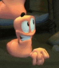 a close up of a cartoon worm sitting on a couch
