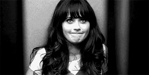 a woman with long hair and bangs is making a funny face .