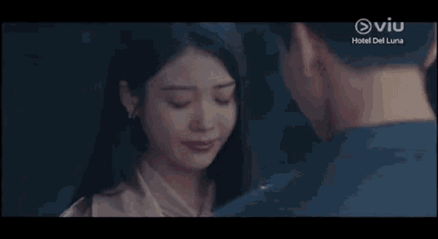 a man and a woman are standing next to each other in a dark room .