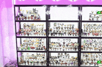a display case filled with lots of funko pop figures and a sign that says sam