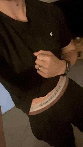 a man wearing a black shirt and abercrombie 's fitch underwear