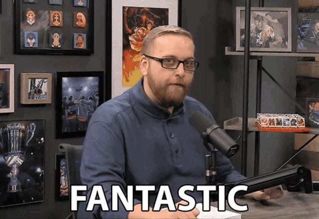a man sitting in front of a microphone with the word fantastic written on the screen