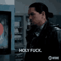 a man is saying holy fuck in front of a tv