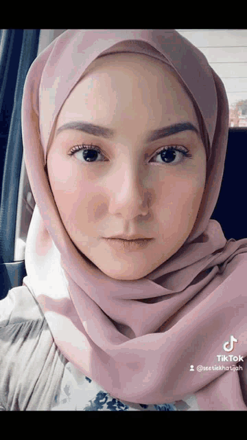 a close up of a woman wearing a hijab