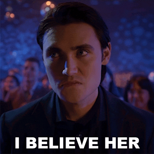 a man in a suit and tie says i believe her