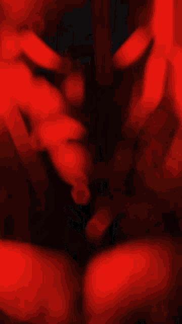 a close up of a person 's face in a red background