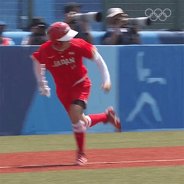a baseball player wearing a red jersey with japan on it