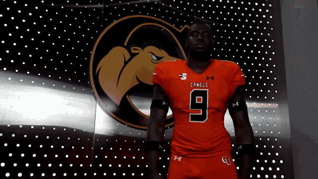 a man wearing an orange jersey with the number 9
