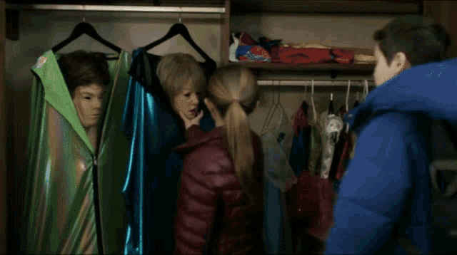 a boy and a girl are standing next to each other in a room