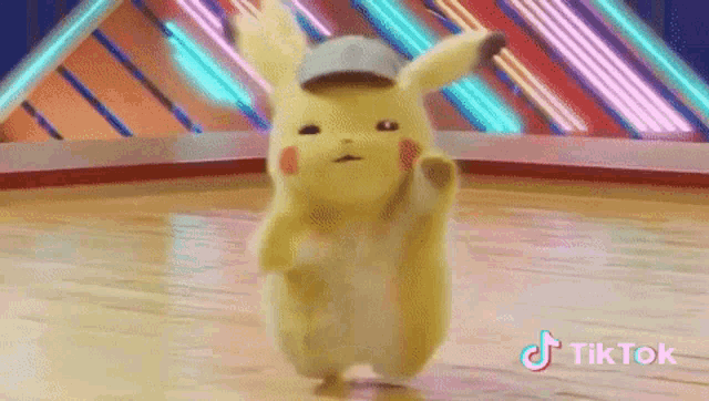 a pikachu with a hat is dancing on a dance floor