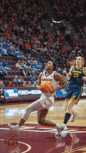 a female basketball player wearing a jersey that says ' hokies ' on it