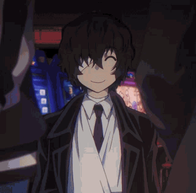 a man in a suit and tie is standing in front of a machine that says ' arcade ' on it