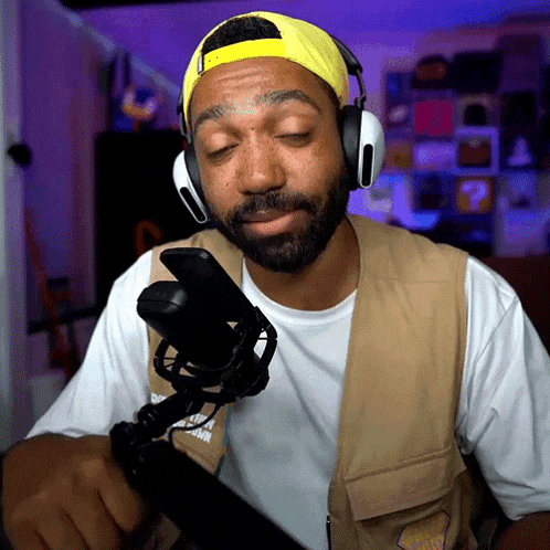 a man with a beard wearing headphones and a vest that says ' nike ' on it