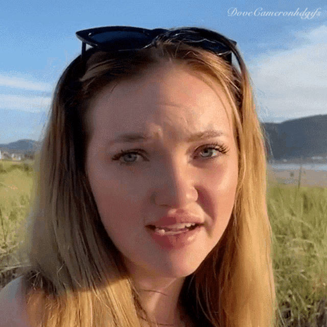 a close up of a woman 's face with the words dove cameron hdgfs on the bottom left