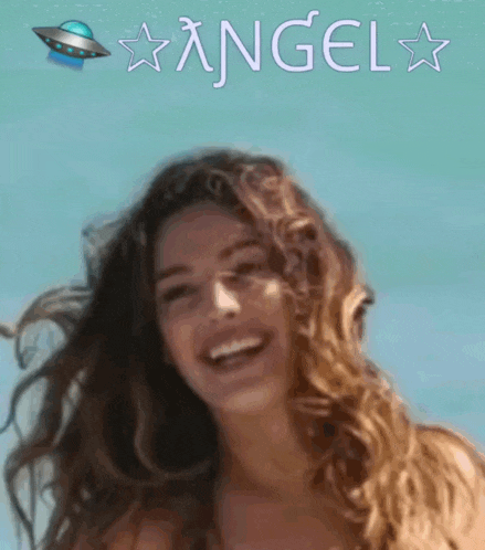 a woman is smiling in front of a blue background with angel written on it