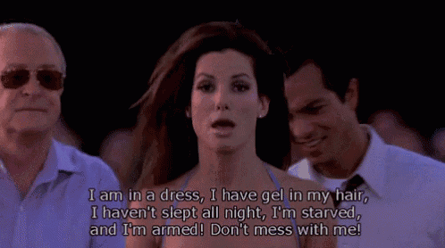 a woman in a dress says i am in a dress i have gel in my hair and i 'm armed