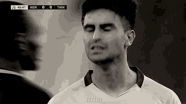 a black and white photo of a soccer player with the score nsr 0 to twn