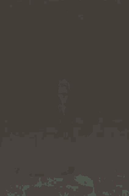 a woman in a black bra and shorts is standing in the dark