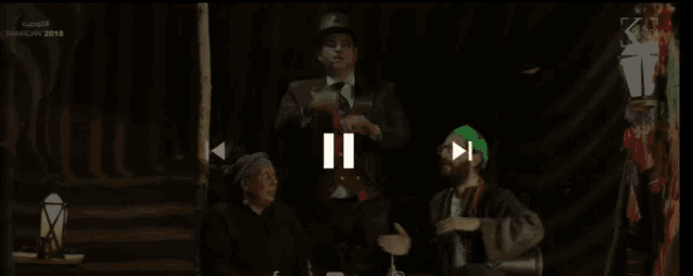 a group of men are sitting around a table with the year 2014 on the bottom left
