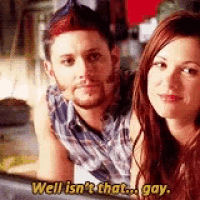 a man and a woman are posing for a picture and the man is saying well isn 't that gay .