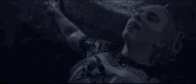 a man is laying on the ground in the rain and laughing .