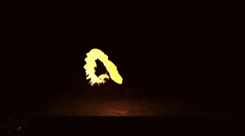 a large fireball is flying through the air on a black background .