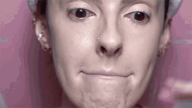 a woman is making a funny face with her mouth open .