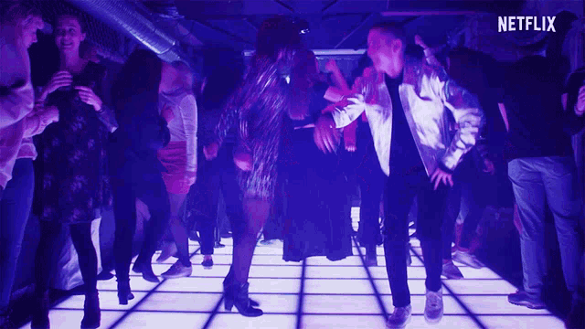 a man and a woman are dancing on a dance floor with a netflix logo behind them