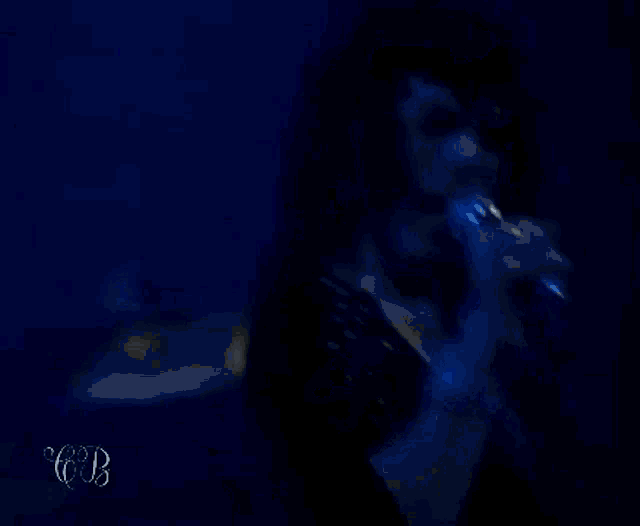 a close up of a woman singing into a microphone .