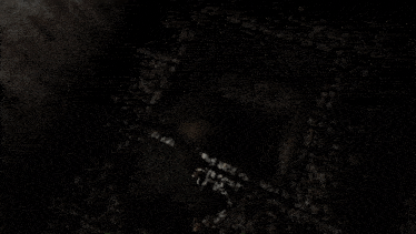 a person is standing in a dark room with a hole in the wall
