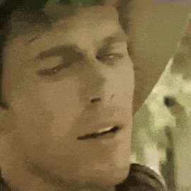 a close up of a man 's face wearing a cowboy hat