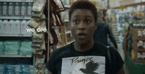 a woman in a black t-shirt with a bird on it is standing in a store .