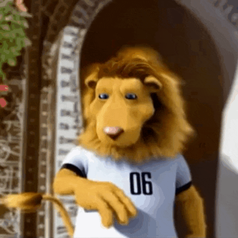 a stuffed lion is wearing a white shirt with the number 06 on it
