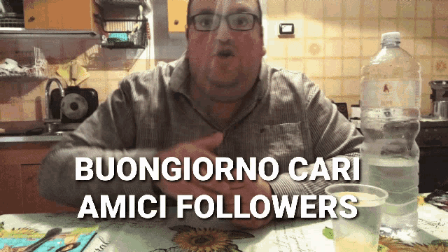 a man sitting at a table with the words buongiorno cari amici followers written on the bottom