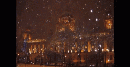 a large building with a clock tower is lit up at night