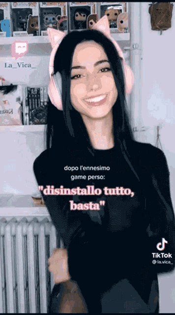 a woman wearing pink headphones with cat ears is smiling ..