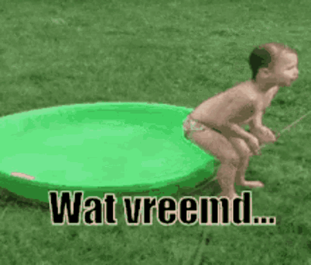 a baby in a bathing suit is jumping into a green swimming pool .