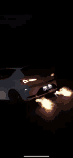a white car with flames coming out of its exhaust pipe