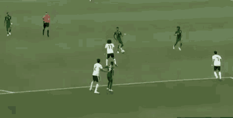 a group of soccer players are playing a game on a soccer field .