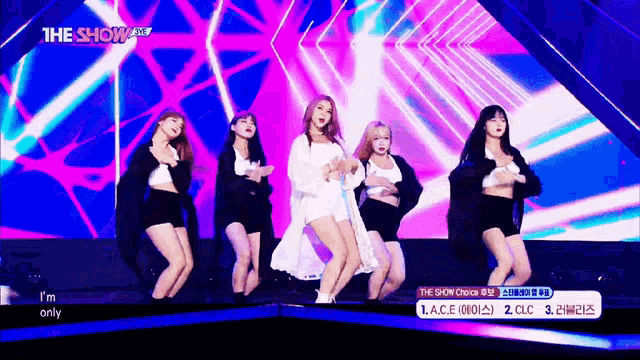 a group of women are dancing on a stage with the words " i 'm only " on the bottom right