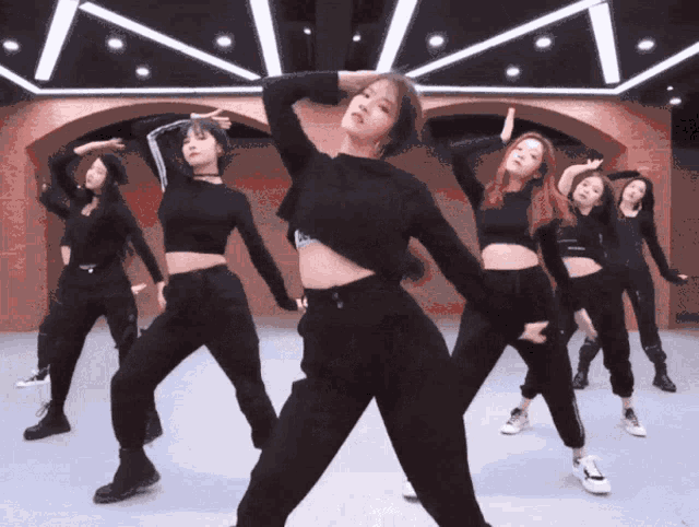 a group of women are dancing together and one of them is wearing a crop top that says ' calvin klein ' on it