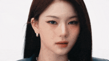 a close up of a woman 's face wearing earrings