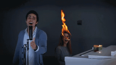 a man singing into a microphone while a woman sings behind him