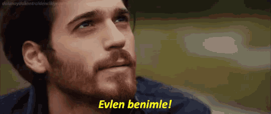 a man with a beard is saying " evlen benimle " .